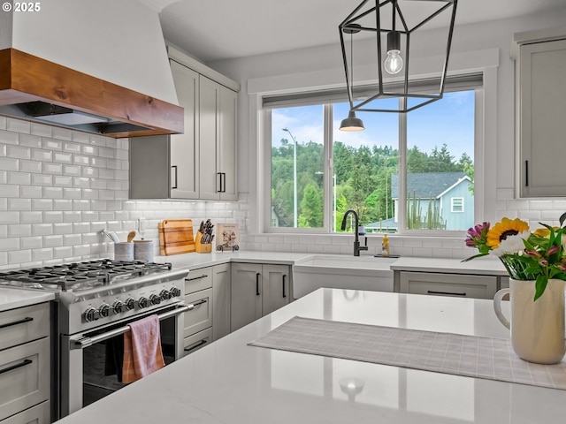3595 Balm St S, Salem, OR 97302 - kitchen featuring custom range hood, high end stainless steel range, healthy amount of natural light, and backsplash