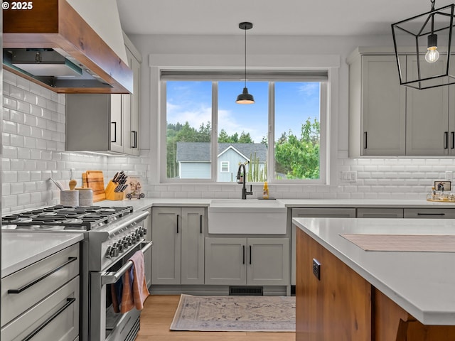 3595 Balm St S, Salem, OR 97302 - kitchen with high end range, premium range hood, light countertops, tasteful backsplash, and light wood finished floors