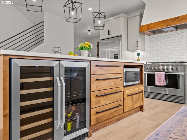 3595 Balm St S, Salem, OR 97302 - kitchen with custom range hood, premium appliances, backsplash, beverage cooler, and light countertops