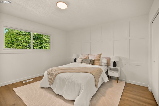 17349 Banyan Ln, Lake Oswego, OR 97034 - bedroom featuring a decorative wall, light wood-style floors, and baseboards
