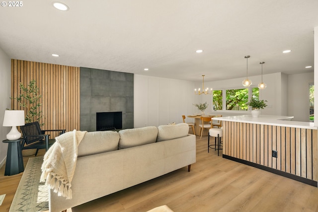 17349 Banyan Ln, Lake Oswego, OR 97034 - living room featuring light wood-style floors, recessed lighting, healthy amount of natural light, a fireplace, and a chandelier