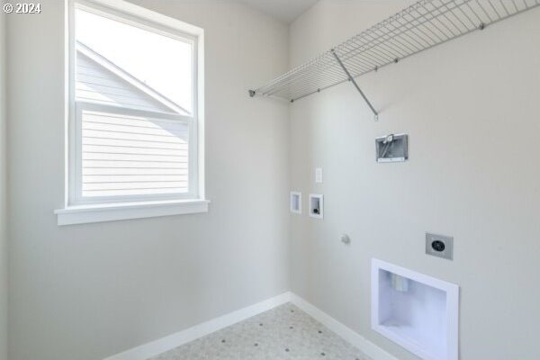 clothes washing area featuring washer hookup, electric dryer hookup, and hookup for a gas dryer