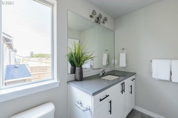 bathroom featuring toilet and vanity