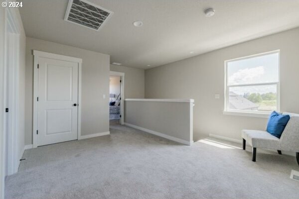 living area with light colored carpet