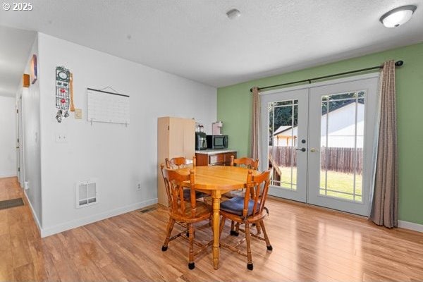 10514 NE 96th St, Vancouver, WA 98662 - dining space with french doors, light wood-style flooring, and baseboards