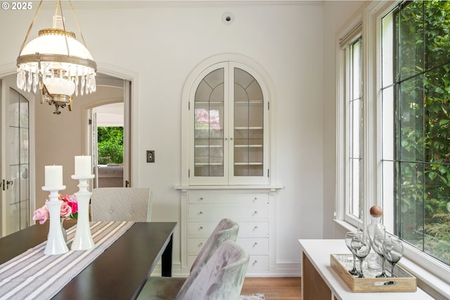 dining room with a chandelier, wood finished floors, and baseboards