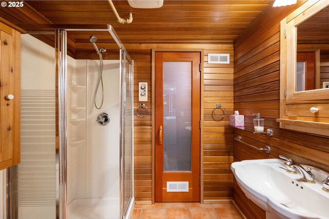 bathroom with wooden ceiling, a shower stall, wooden walls, and a sink