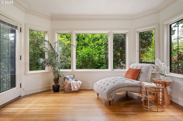 sunroom featuring crown molding, wood finished floors, and baseboards