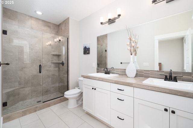 bathroom with vanity, toilet, a shower with door, and tile patterned flooring