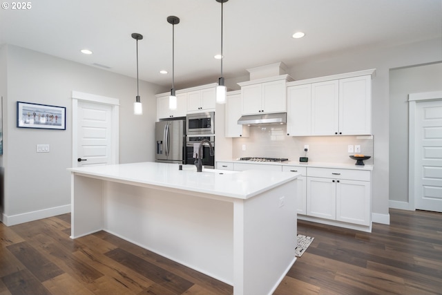 kitchen featuring white cabinetry, appliances with stainless steel finishes, and a kitchen island with sink