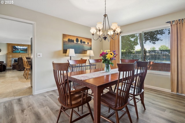 17958 Saint Clair Dr, Lake Oswego, OR 97034 - dining room with a chandelier, wood finished floors, and a fireplace