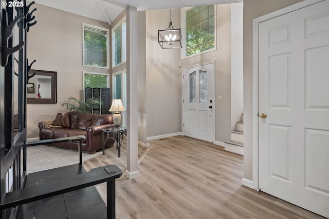 17958 Saint Clair Dr, Lake Oswego, OR 97034 - foyer entrance with a chandelier, stairway, light wood finished floors, and a towering ceiling