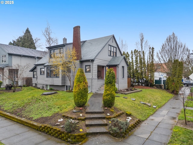 view of front of house with a front yard and a chimney