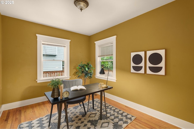 office area with wood finished floors and baseboards