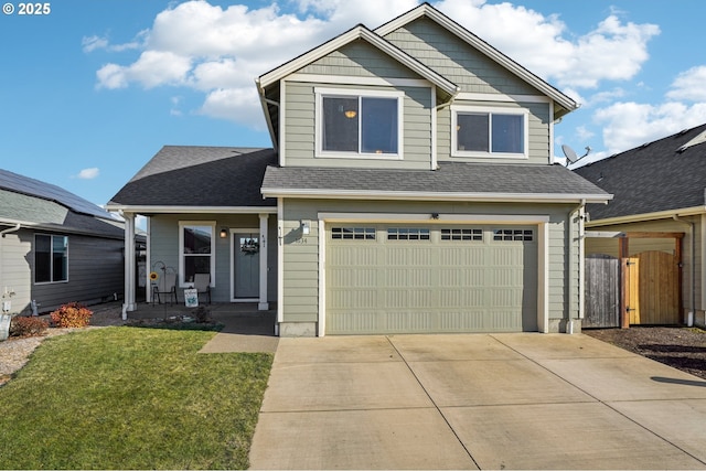 view of front of house with a garage, a front yard, and covered porch