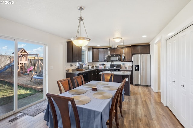 dining space featuring sink and light hardwood / wood-style floors