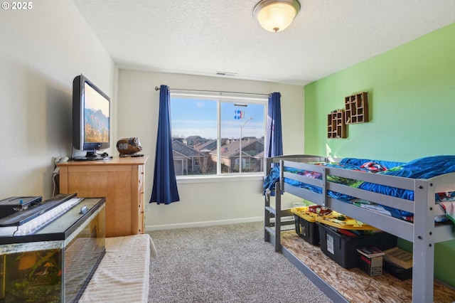 carpeted bedroom with a textured ceiling