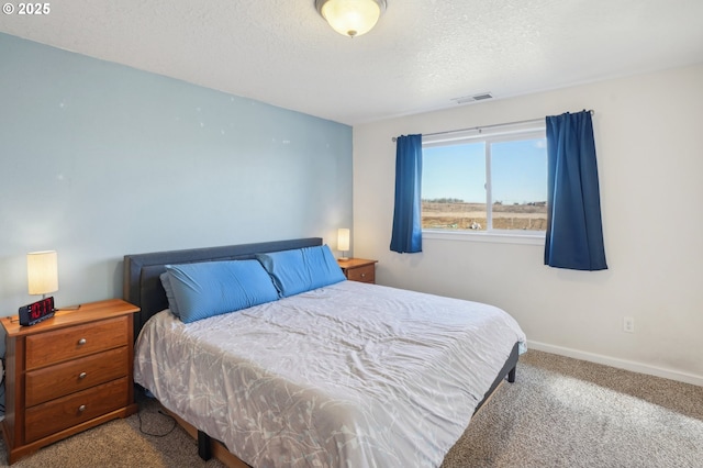 carpeted bedroom with a textured ceiling