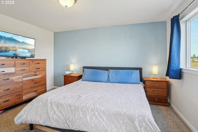 bedroom featuring a textured ceiling and carpet flooring