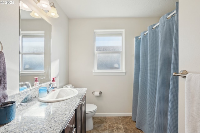 bathroom featuring vanity, toilet, tile patterned floors, and a shower with curtain