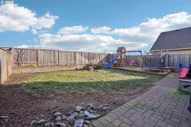 view of playground with a yard and a trampoline