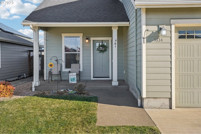 view of exterior entry featuring a lawn and covered porch