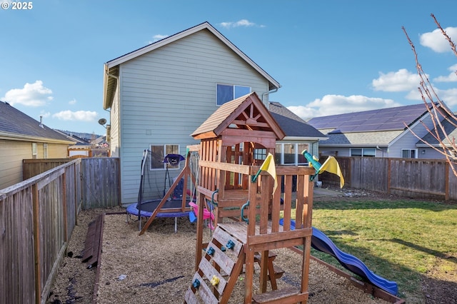 view of play area featuring a yard and a trampoline