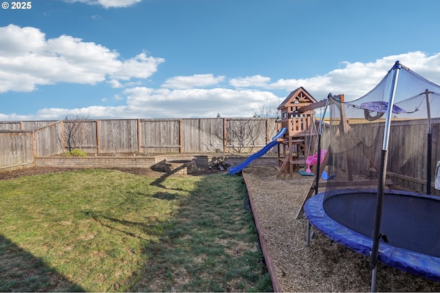 view of play area with a trampoline and a lawn