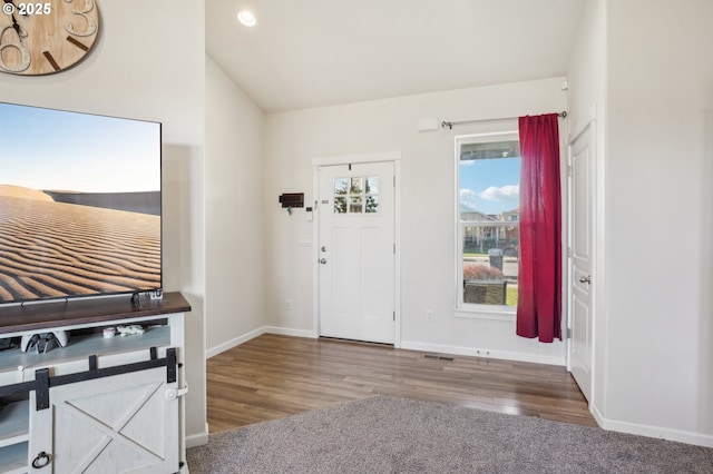 foyer featuring lofted ceiling and hardwood / wood-style floors