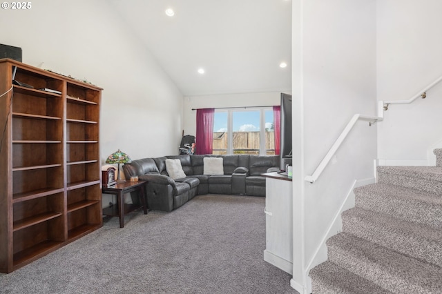 carpeted living room with high vaulted ceiling