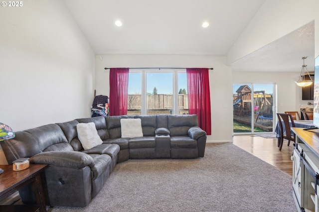 living room featuring vaulted ceiling and carpet