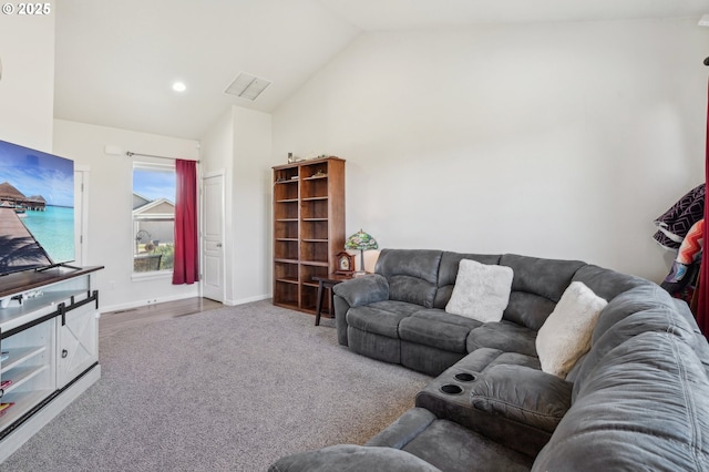 living room with high vaulted ceiling and carpet