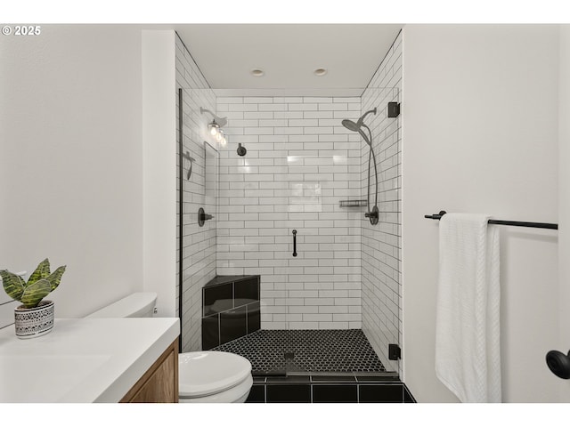 bathroom with vanity, recessed lighting, a stall shower, and toilet