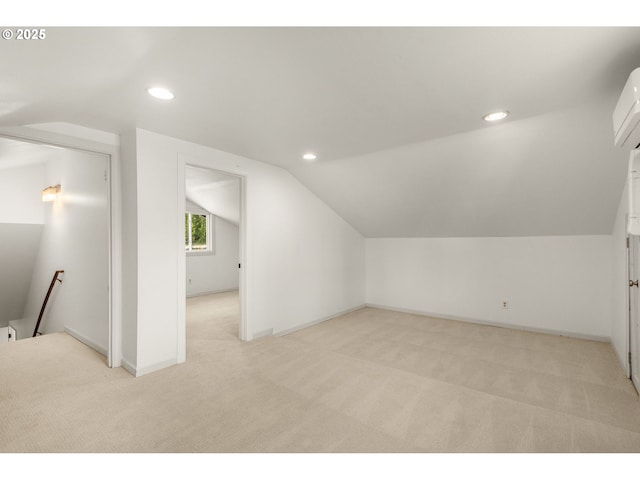 bonus room featuring baseboards, vaulted ceiling, recessed lighting, and light colored carpet