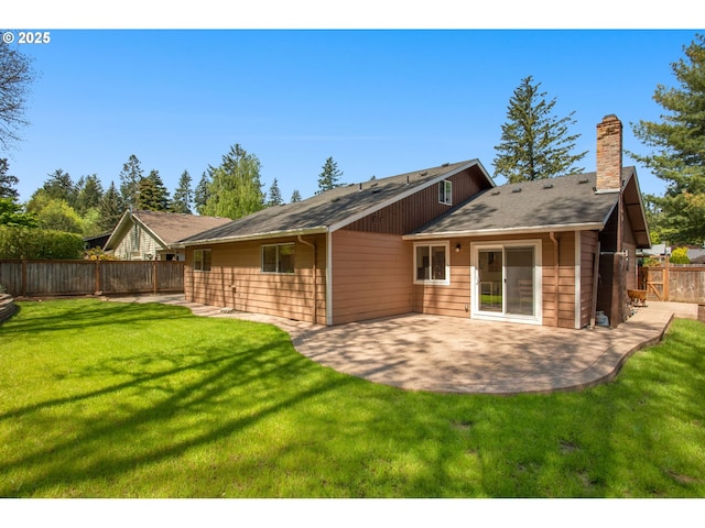 rear view of property with a patio, a fenced backyard, a yard, and a chimney
