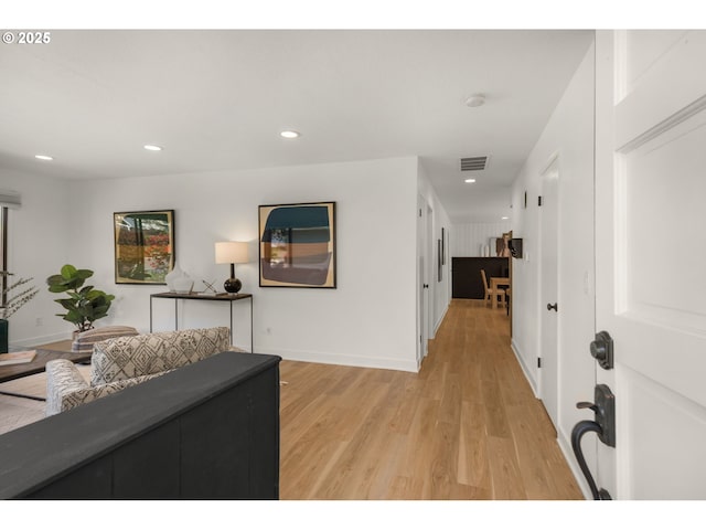 hall featuring recessed lighting, baseboards, light wood finished floors, and visible vents