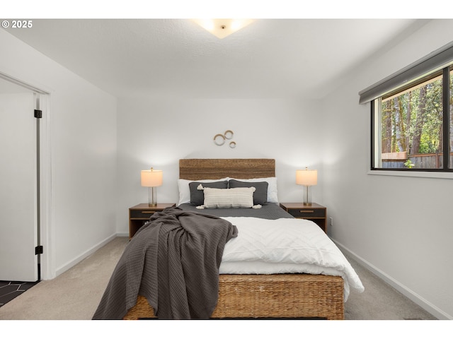 carpeted bedroom featuring baseboards