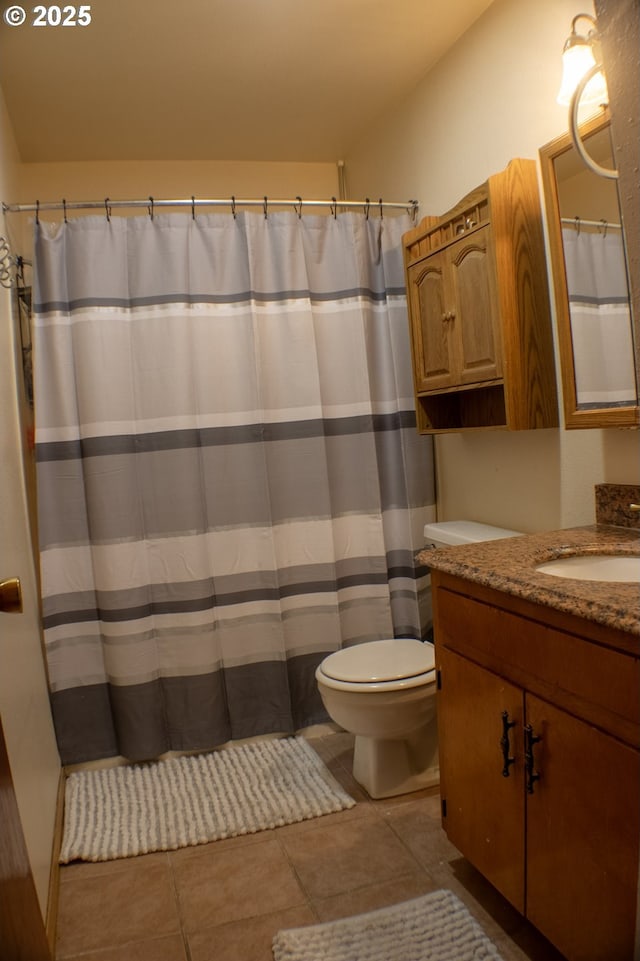 bathroom with vanity, toilet, and tile patterned flooring