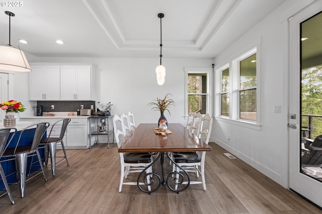 50322 Briarwood Ct, Scappoose, OR 97056 - dining room with light wood finished floors, a tray ceiling, and recessed lighting