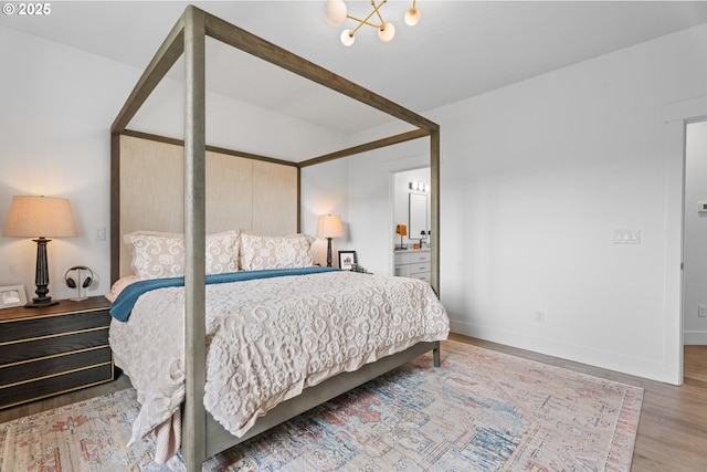 50322 Briarwood Ct, Scappoose, OR 97056 - bedroom with wood finished floors, a chandelier, and connected bathroom