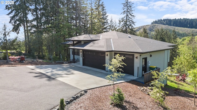 50322 Briarwood Ct, Scappoose, OR 97056 - view of home's exterior featuring asphalt driveway, a mountain view, a garage, and a shingled roof