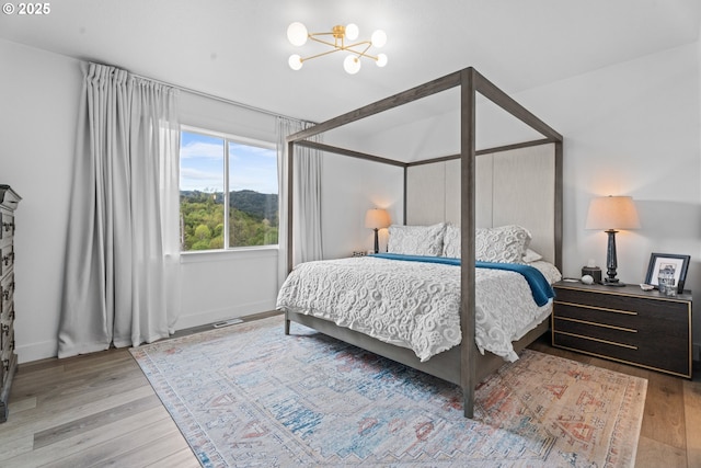 50322 Briarwood Ct, Scappoose, OR 97056 - bedroom with a chandelier and wood finished floors