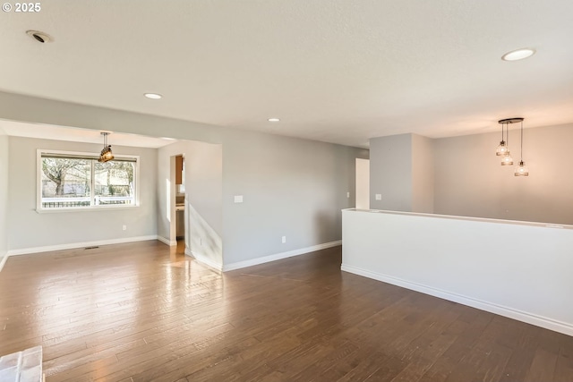 empty room with dark wood-type flooring