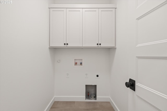 clothes washing area featuring cabinets, washer hookup, hookup for an electric dryer, light tile patterned flooring, and gas dryer hookup