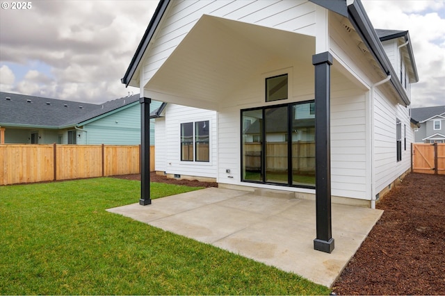 rear view of property with a patio area and a yard