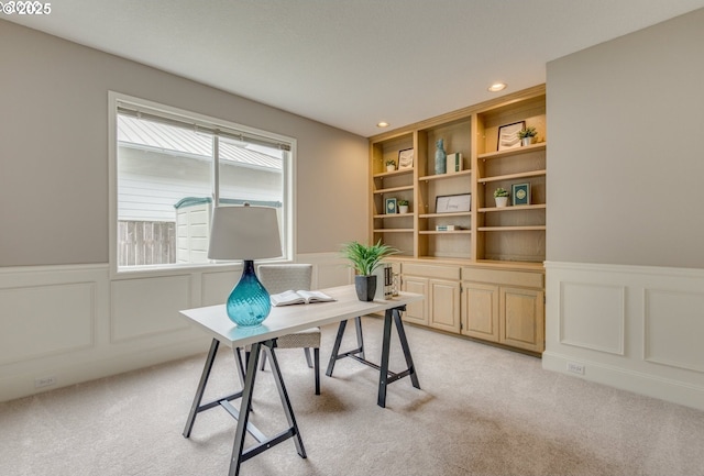 home office with built in features and light carpet