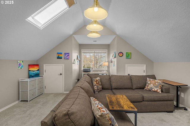 living room with light colored carpet, vaulted ceiling with skylight, and a textured ceiling