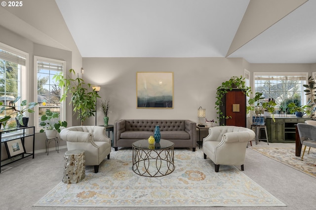 carpeted living room with lofted ceiling