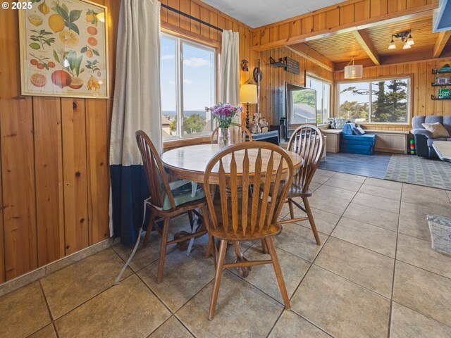 1749 NE 19th St, Lincoln City, OR 97367 - dining space featuring wooden walls, light tile patterned flooring, and beamed ceiling