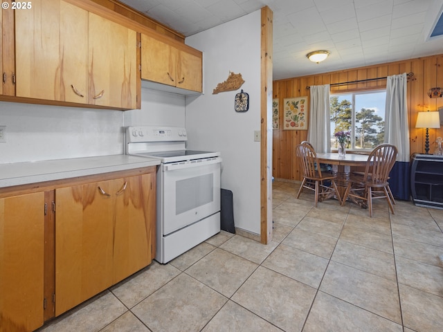 1749 NE 19th St, Lincoln City, OR 97367 - kitchen with white electric range oven, wooden walls, light countertops, and light tile patterned floors